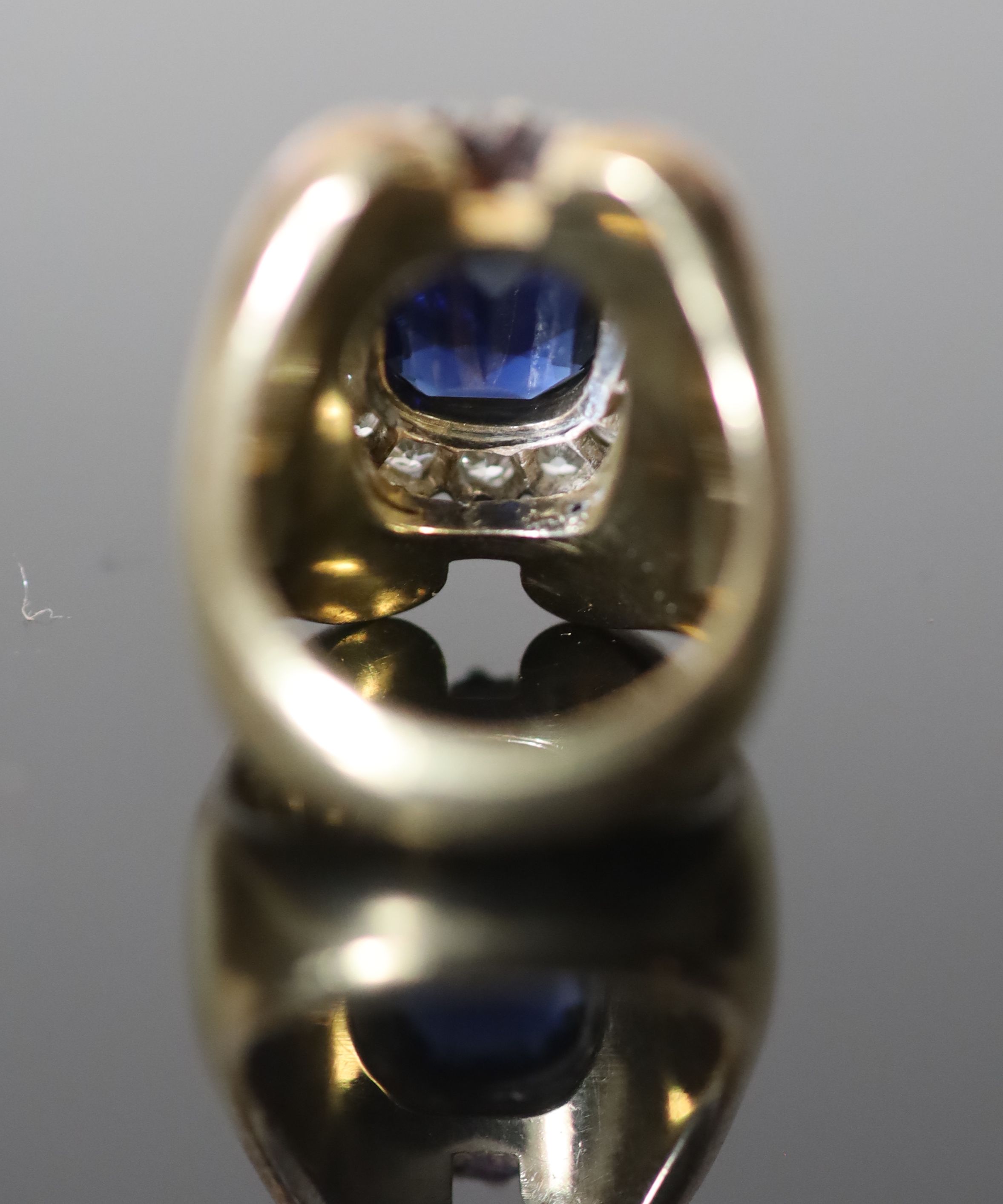 A large modern 18k gold (stamped 750), synthetic sapphire and diamond cluster set dress ring,